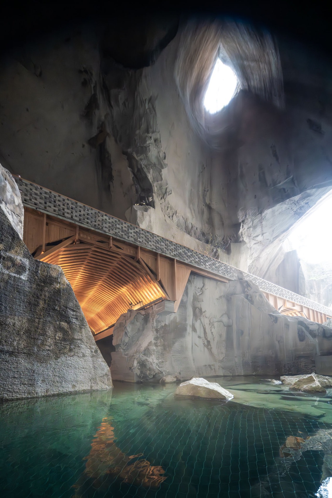 Daylight entering above an interlocking timber arch