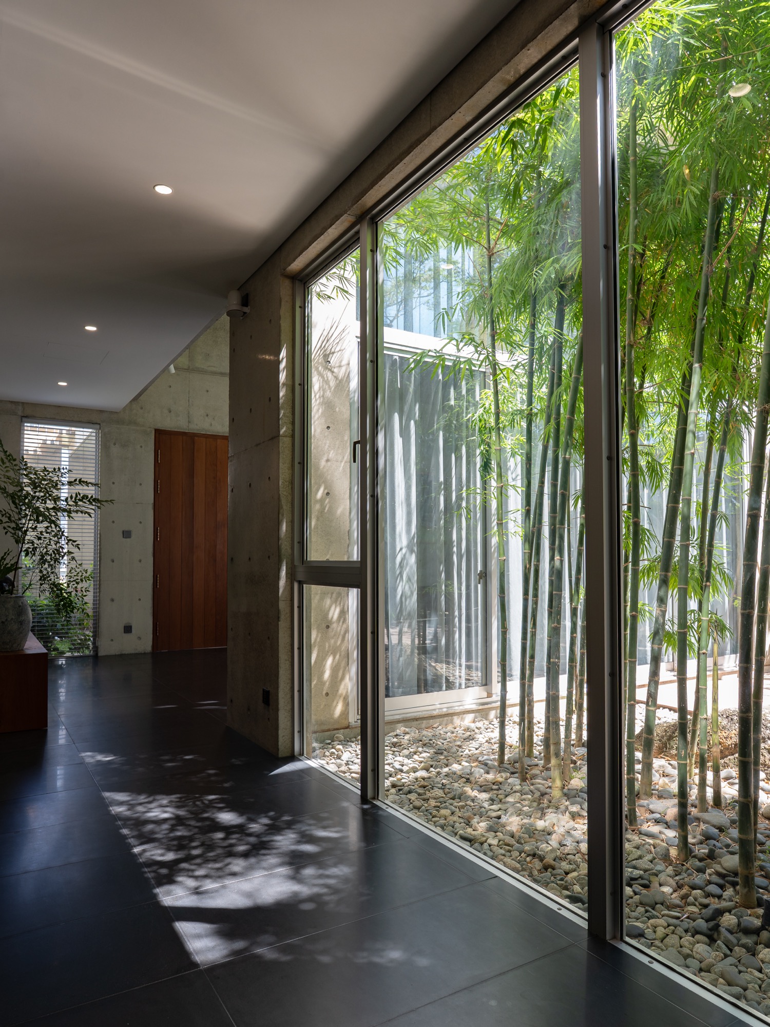 Corridor along glazing beside the bamboo garden