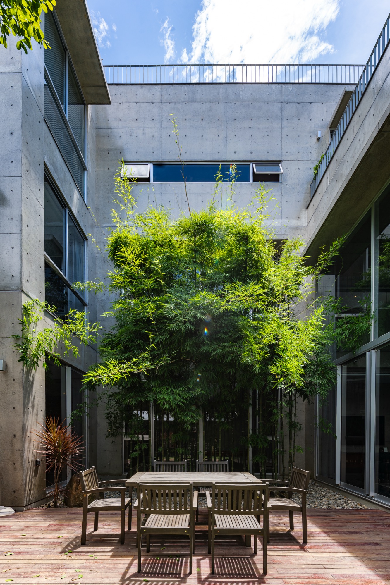 Courtyard seen from above with dining table and tree