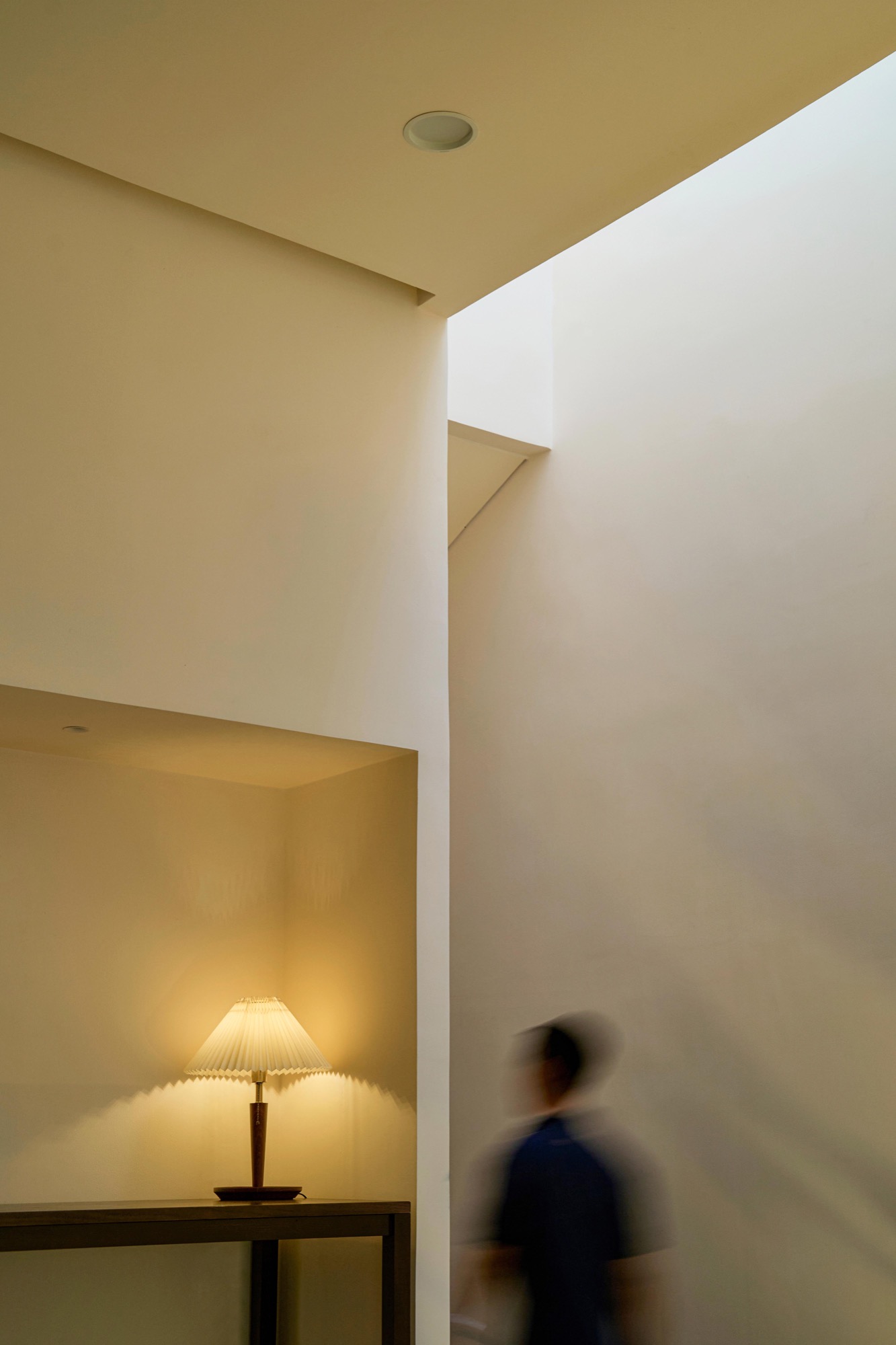 Light falling down a tall wall beside a low space