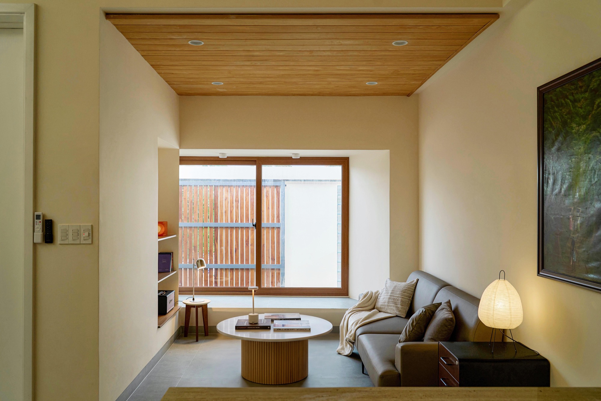 Living room with timber ceiling and a window to the court