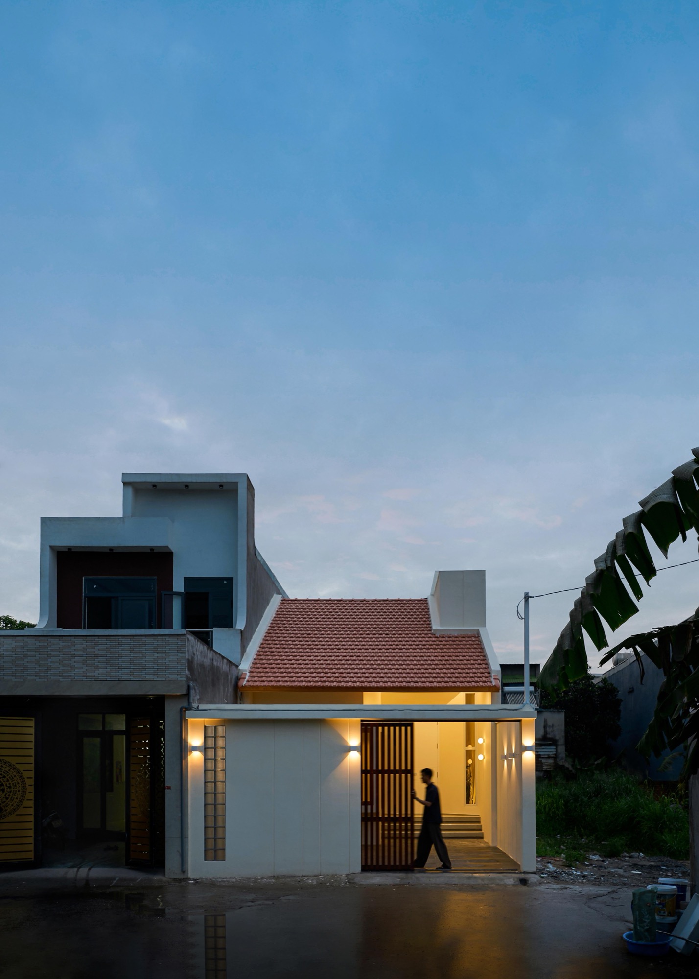 The house glowing at dusk