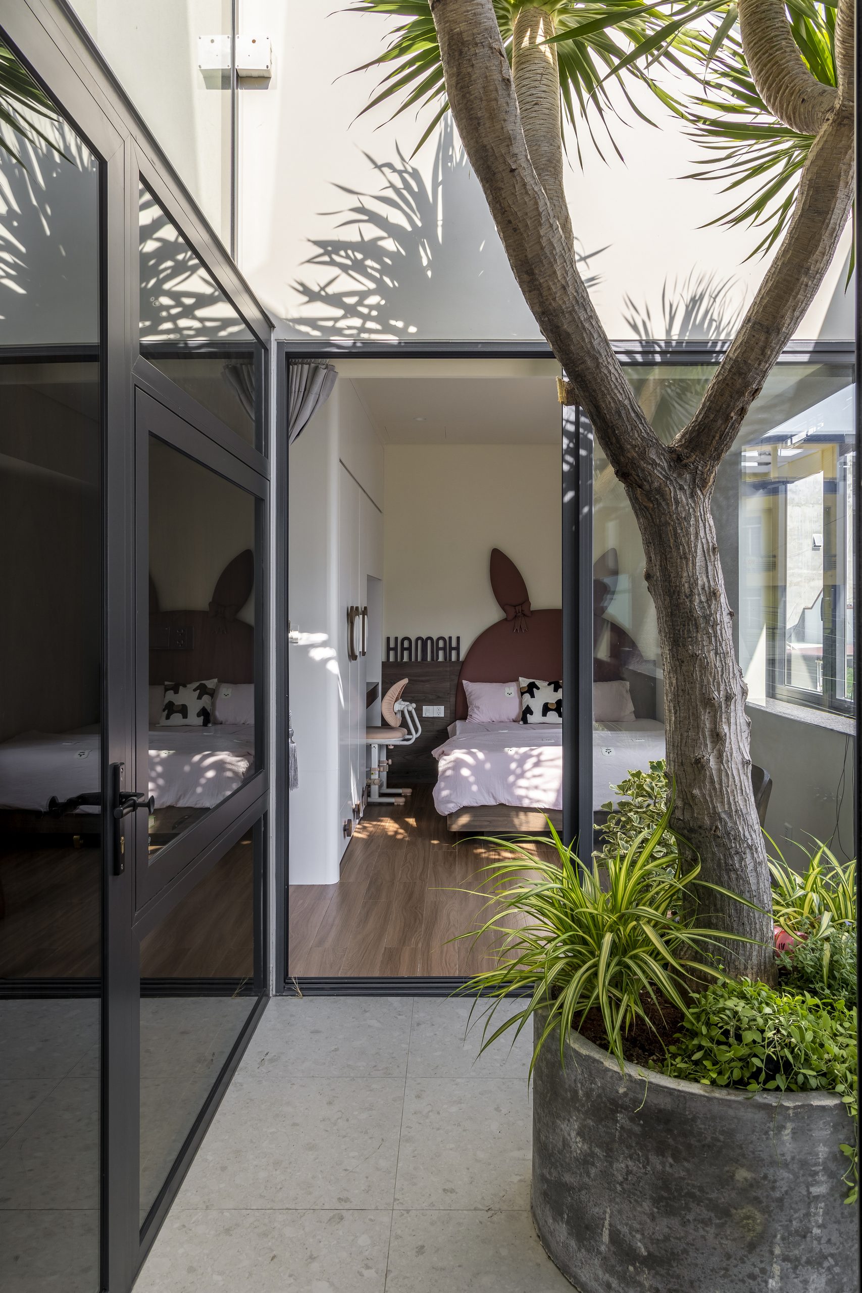 Courtyard tree outside a glazed bedroom door