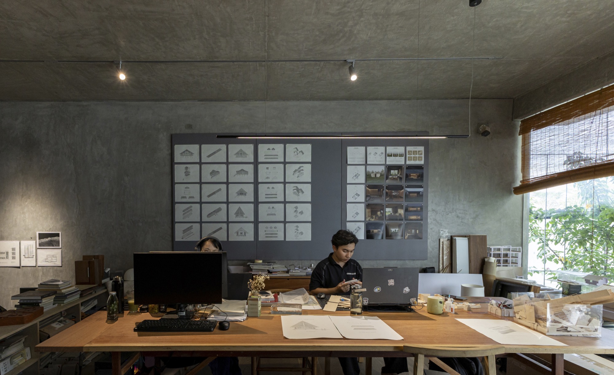Desk area with drawings pinned to the wall