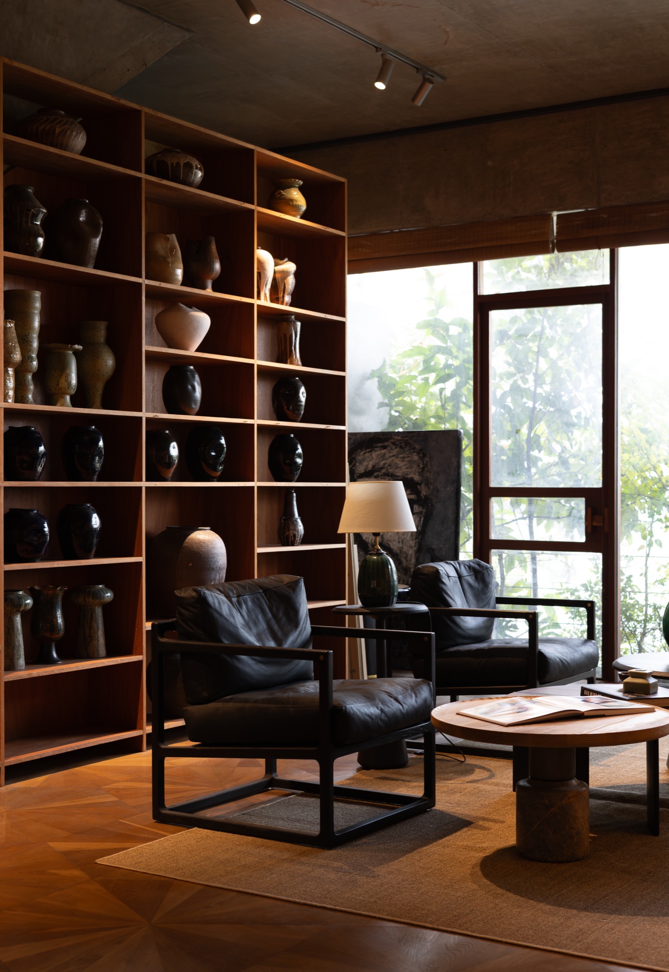 Armchairs beside a tall display shelf