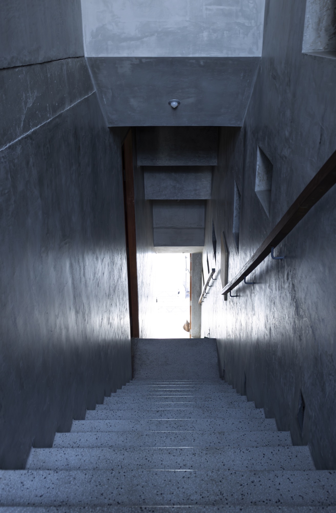 Narrow stair in dark concrete