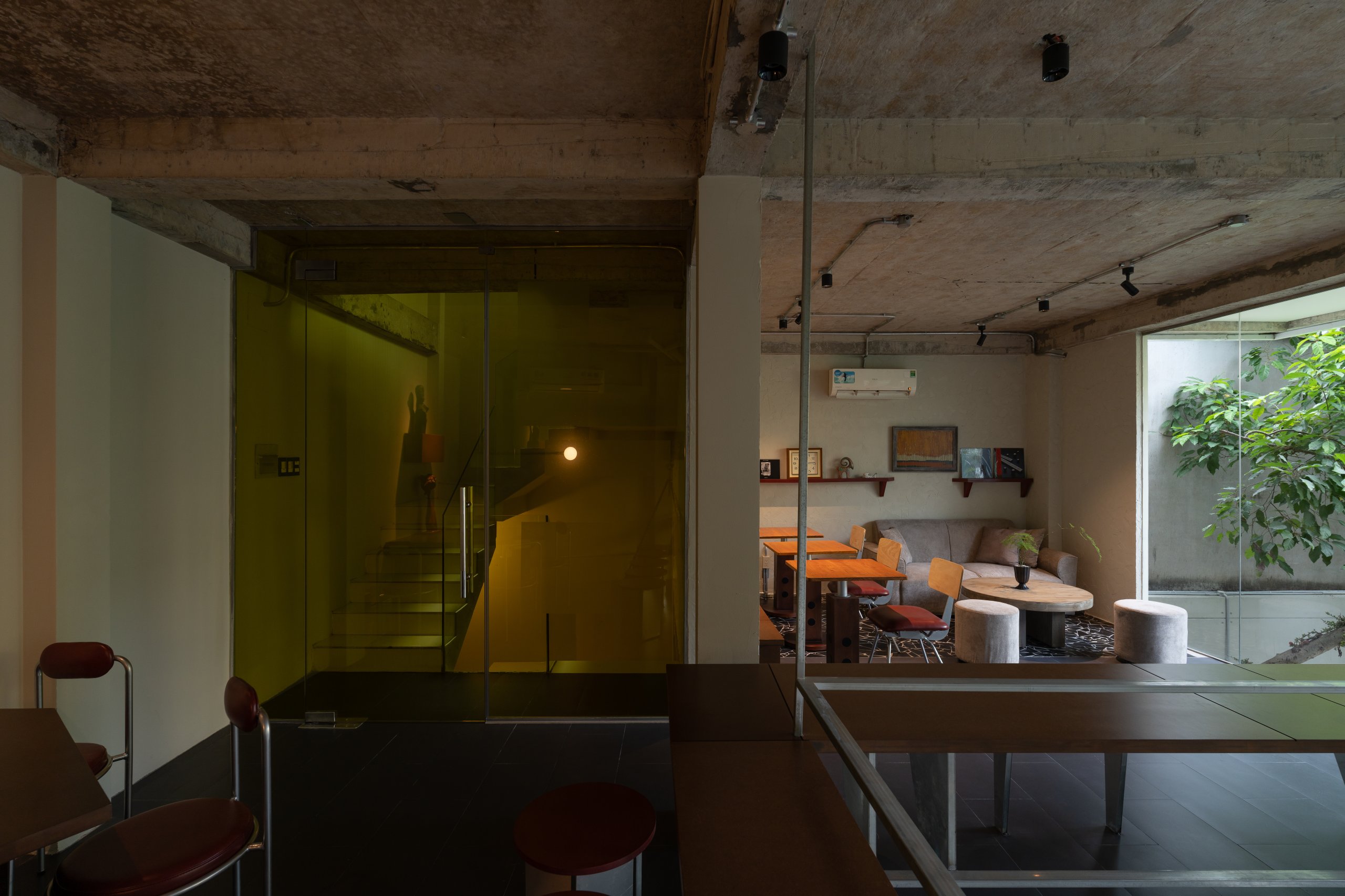 Day1 Cafe by oh.hi studio, upper-level seating in low light