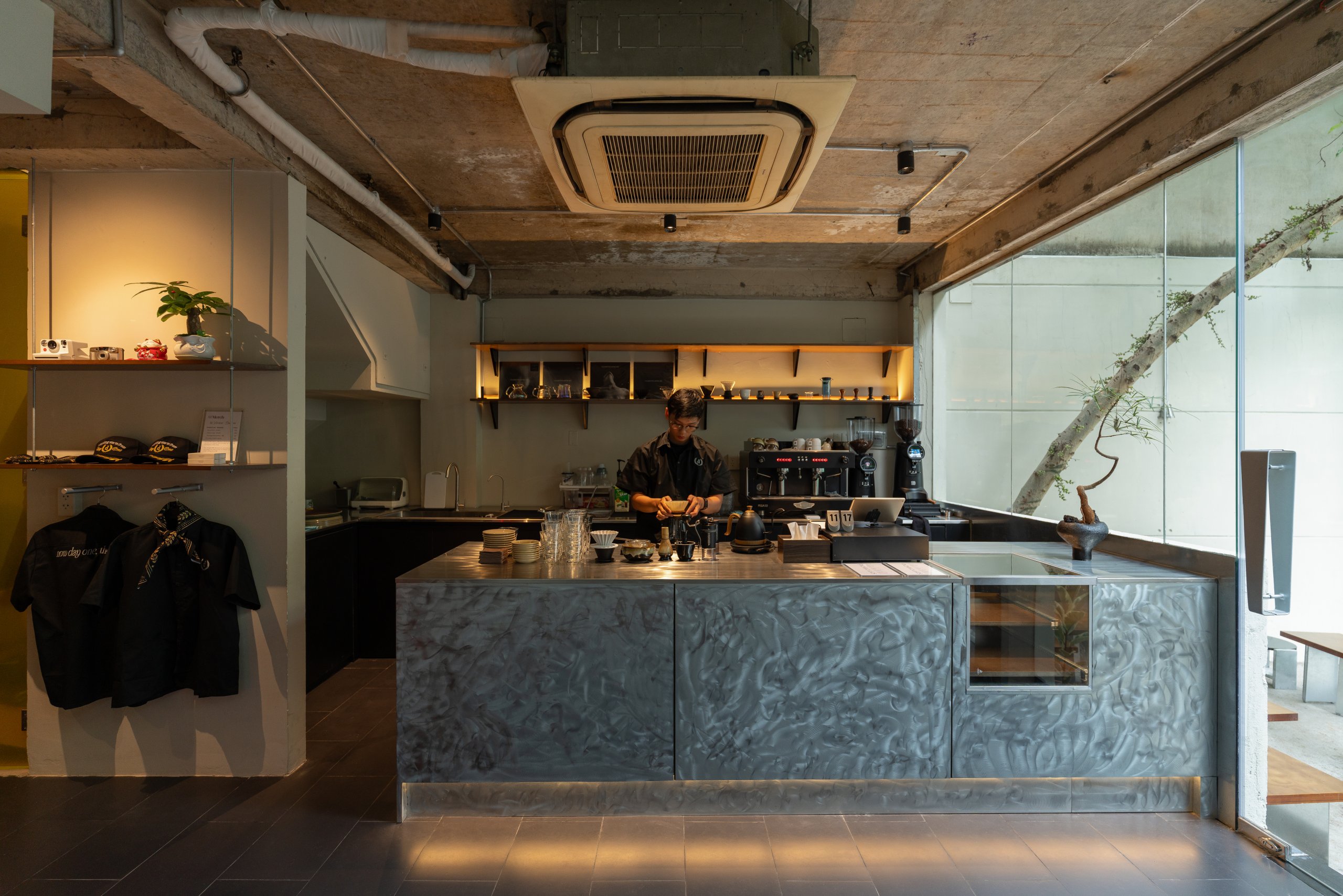 Day1 Cafe by oh.hi studio, bar counter under the exposed concrete ceiling