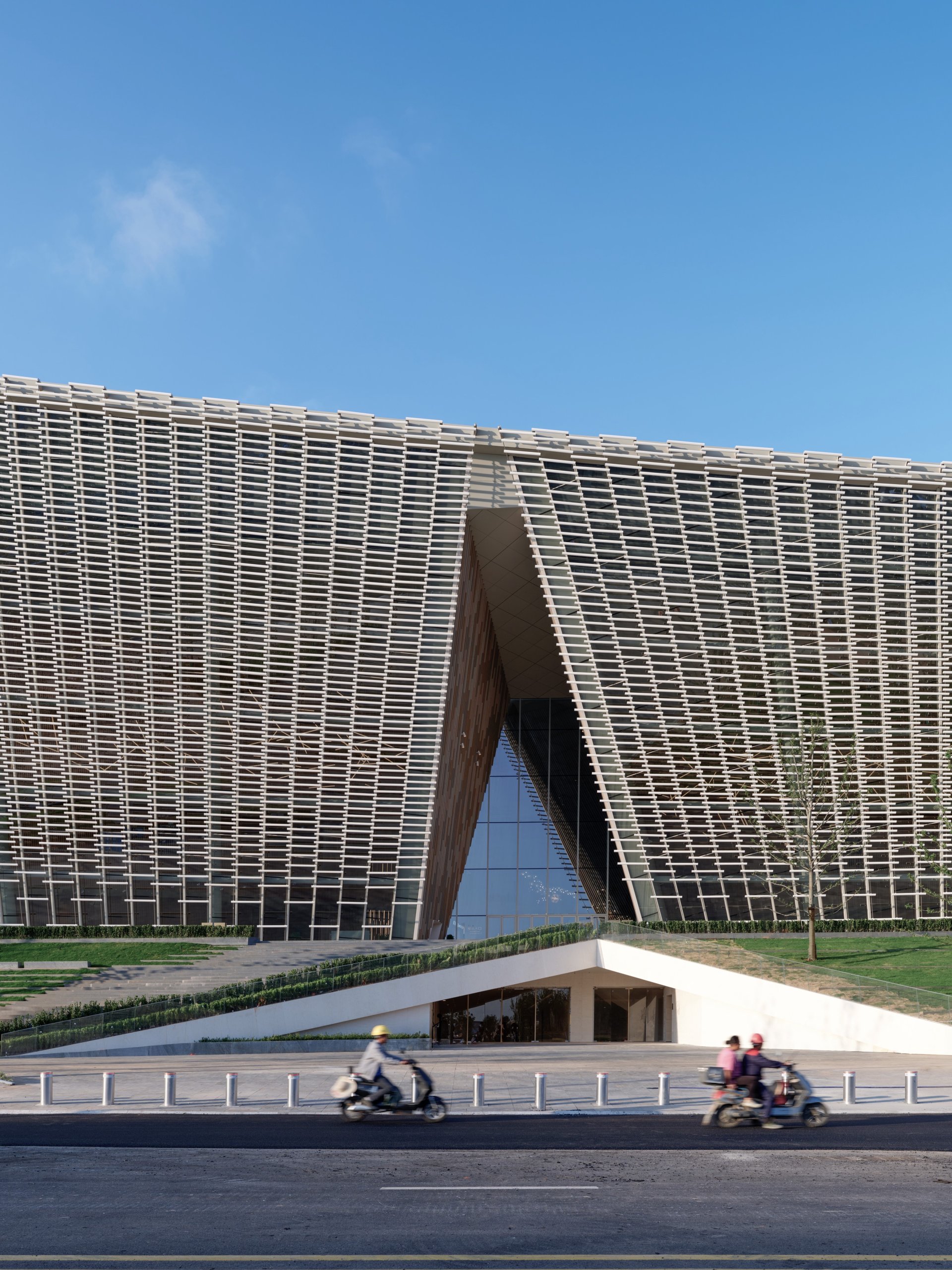 Entrance cut into the ceramic facade