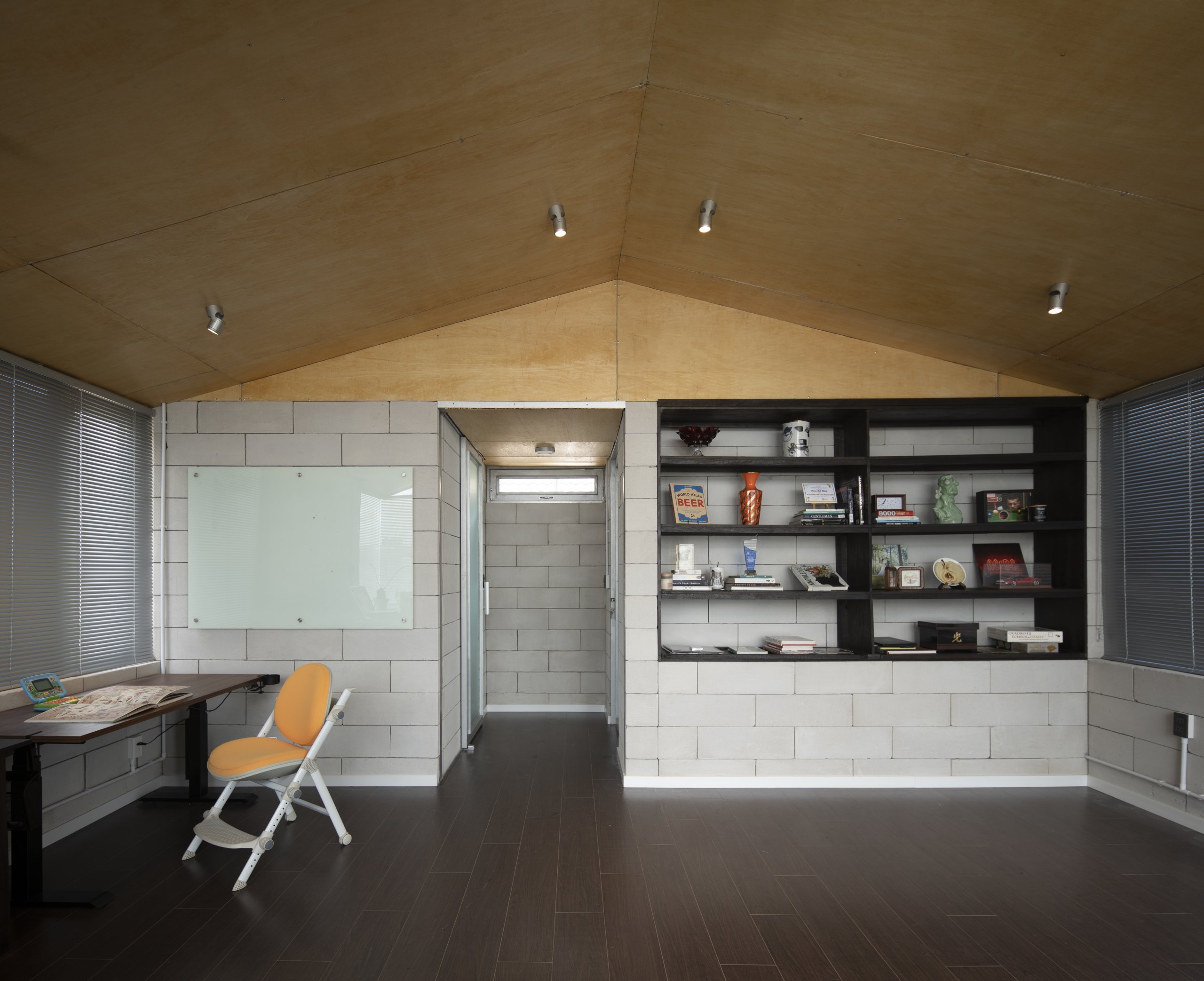 Room Above by scale50, Ho Chi Minh City, desk and shelving along the block wall